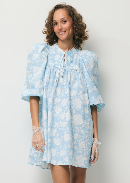 Uśmiechnięta modelka ubrana w mini sukienkę AYOTE.