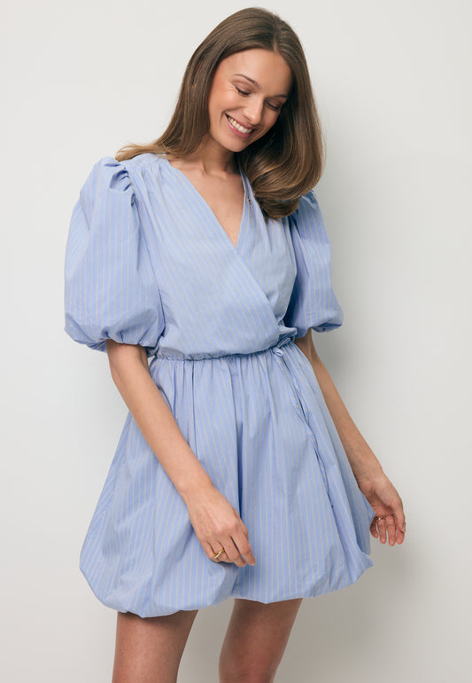 Uśmiechnięta modelka w mini sukience z kopertowym dekoltem CELESTA.