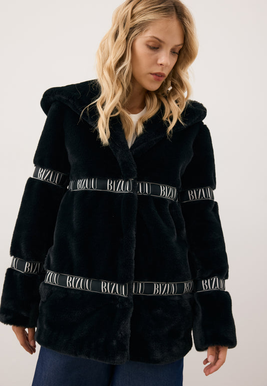 Modelka patrząca w bok ubrana w czarne logowane futerko z kapturem MIALNO.