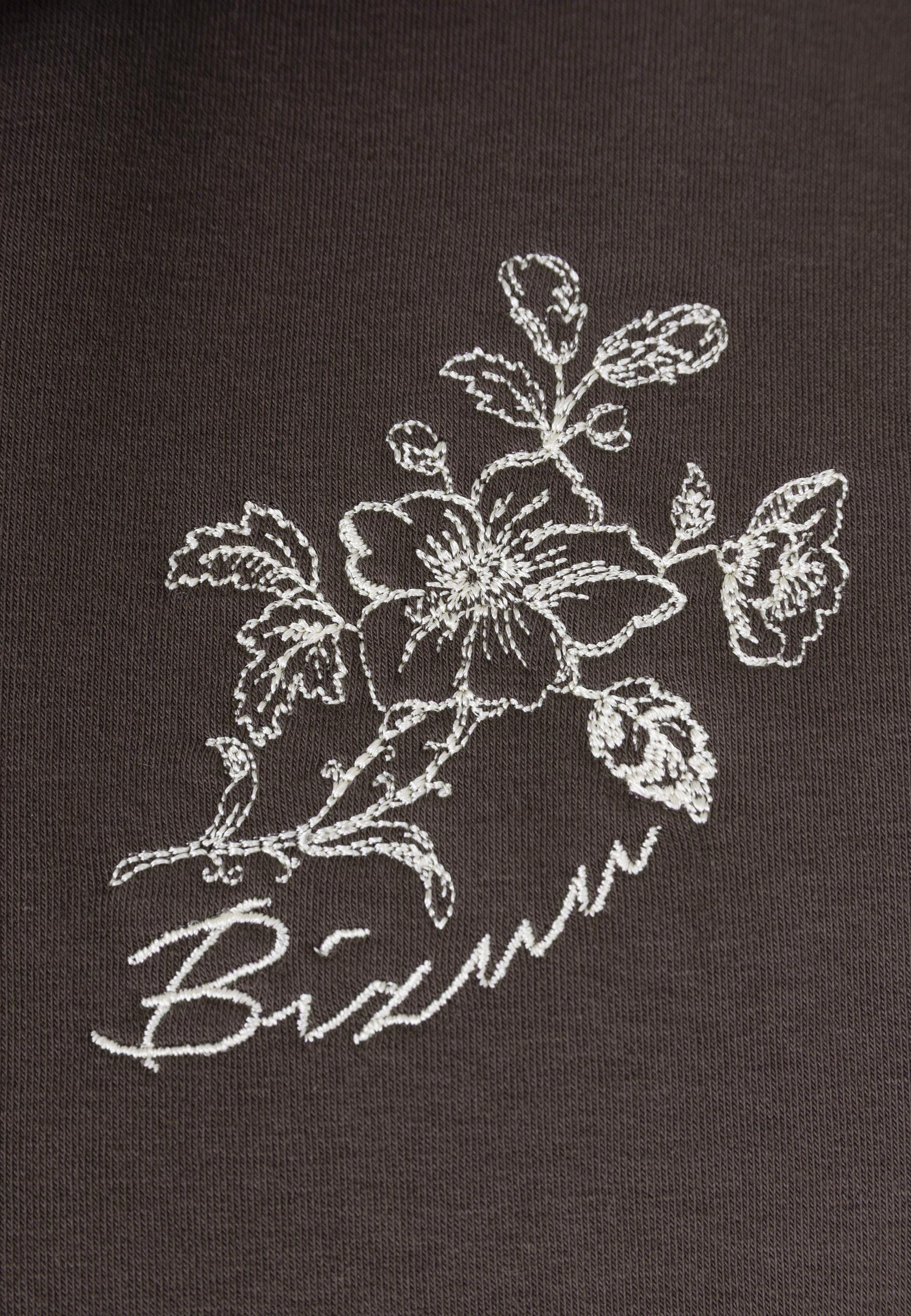 Zbliżenie na haft z logo na przodzie bluzy TANSY.
