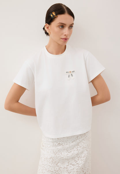 Oversizowy T-shirt z logowaną kokardką TISHALLE kremowy