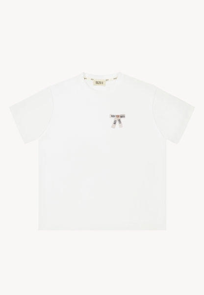 Oversizowy T-shirt z logowaną kokardką TISHALLE kremowy