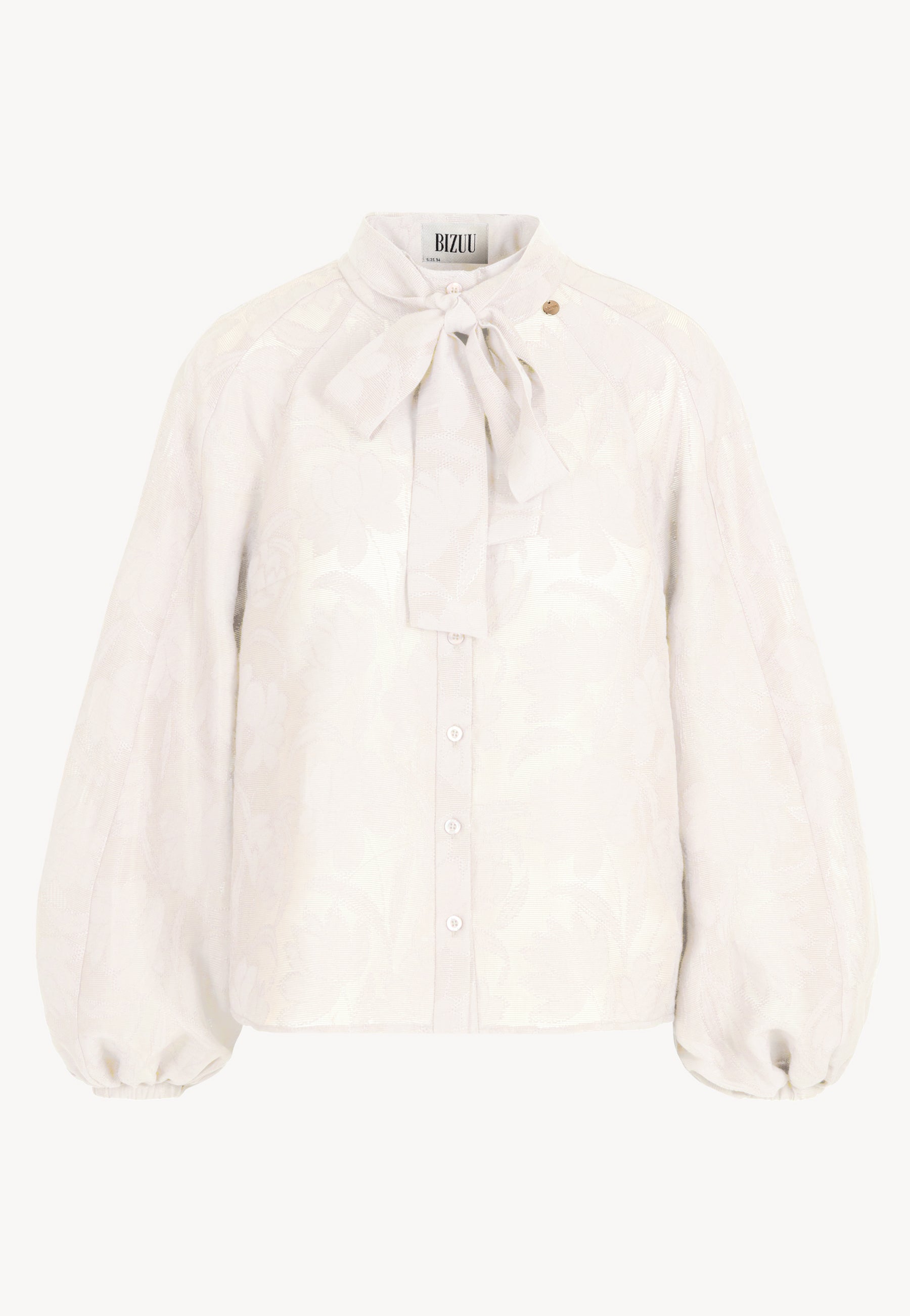 Kremowa bluzka VALEA w kwiatowy wzór z ozdobną wstążką przy kołnierzu.